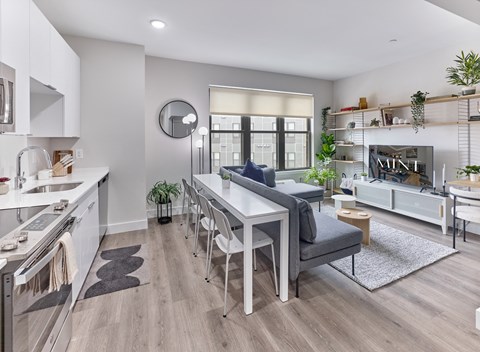 a living room and dining room with a table and chairs